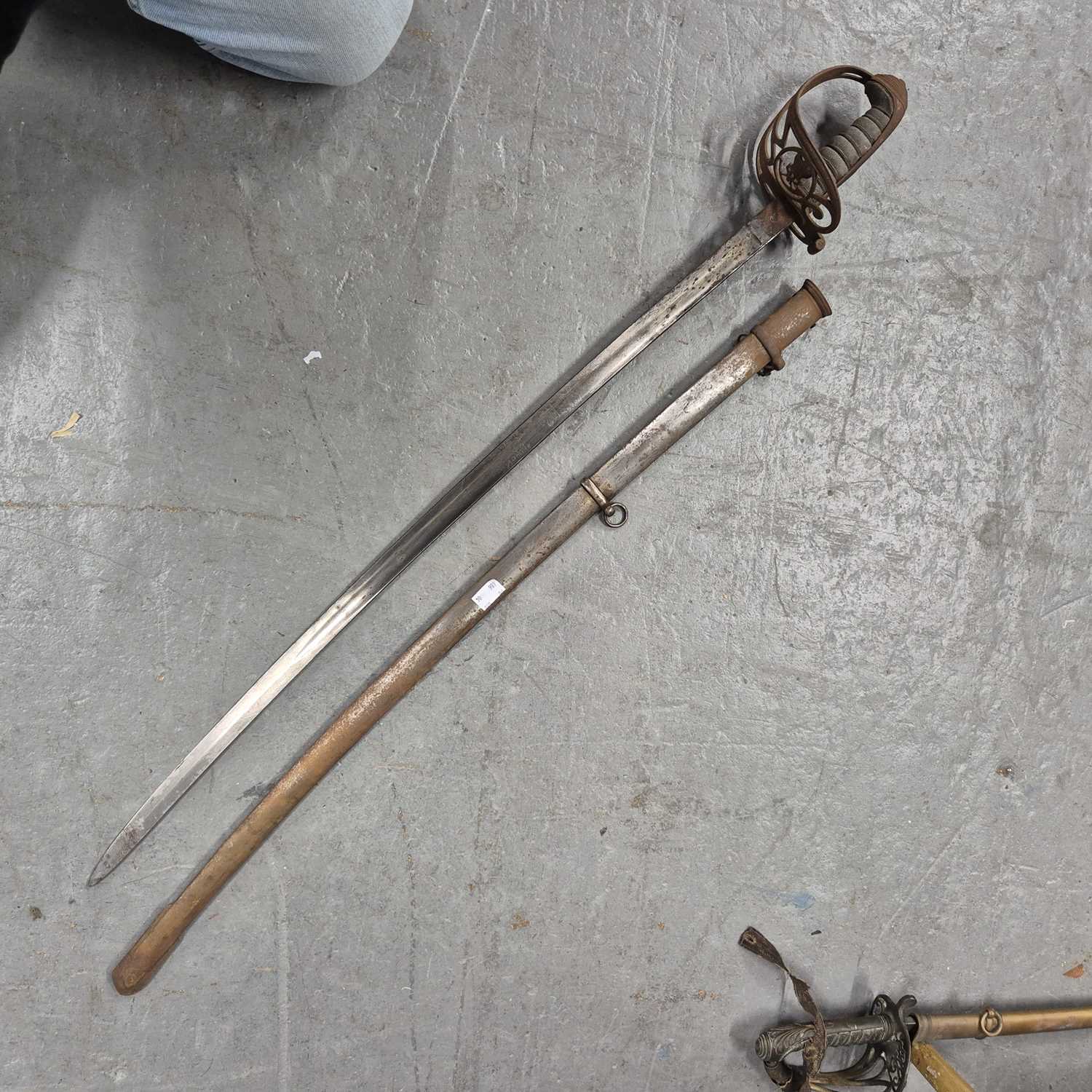 Lot 151 - An antique infantry sword in a steel scabbard.