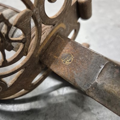 Lot 151 - An antique infantry sword in a steel scabbard.