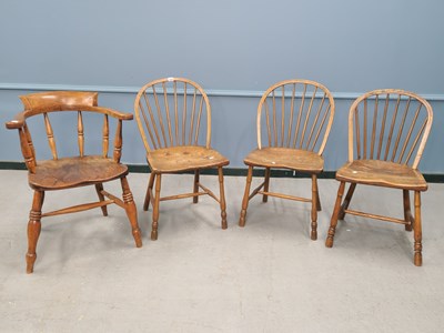 Lot 1369 - A set of three oak and elm hoop back chairs...