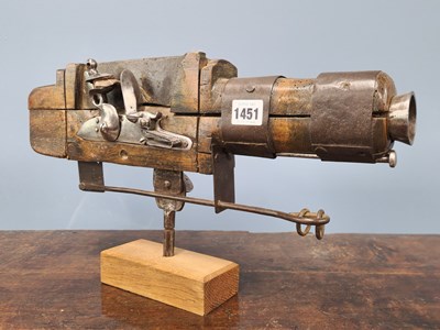 Lot 1451 - A flintlock gun firing by a trip mechanism, a...