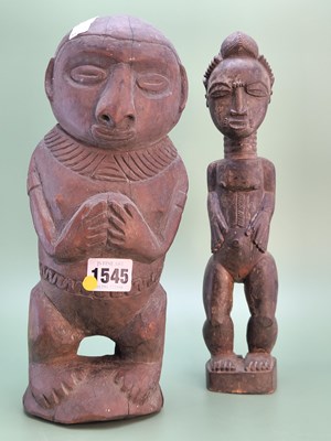 Lot 1545 - An African carved wood female figure, possibly...