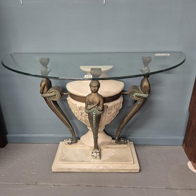 Lot 197 - An unusual glass top console table. H 79 W 106...