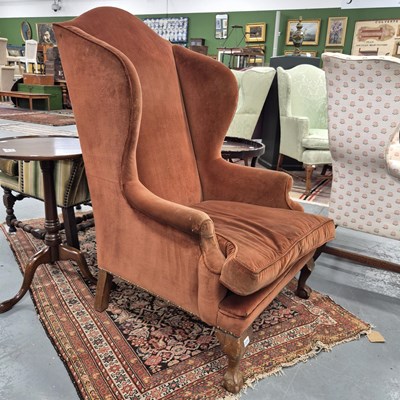 Lot 371 - A wing back armchair on short cabriole legs...