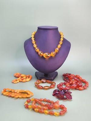 Lot 1082 - A collection of eight strings of amber and...