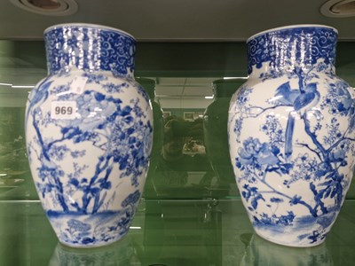 Lot 969 - A pair of Japanese blue and white vases...