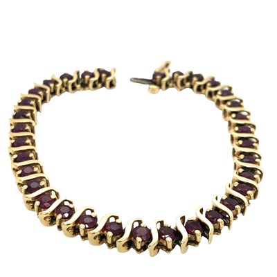 Lot 1119 - A garnet set line bracelet, stamped 14k,...