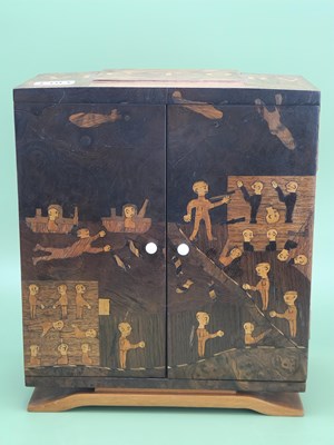 Lot 1304 - A WWII marquetry table top cabinet, the top...