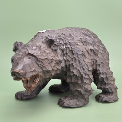 Lot 1302 - A Black Forest carved wooden bear growling as...