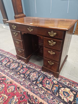 Lot 1297 - A George III mahogany kneehole desk, a long...