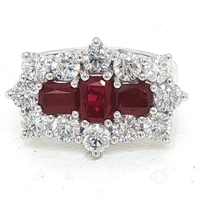 Lot 1059 - A platinum cluster ring set with step-cut...