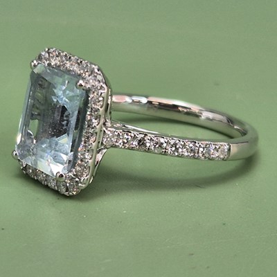 Lot 1060 - A platinum cluster ring with a step cut...