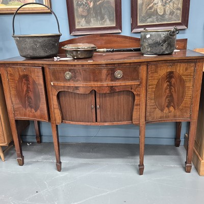 Lot 17 - An antique mahogany serpentine front sideboard...