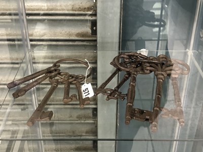 Lot 571 - Two rings of vintage iron door keys