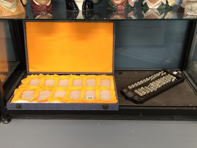 Lot 589 - A case of twelve Cinese muttonfat jade...