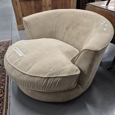 Lot 90 - A large contemporary swivel armchair