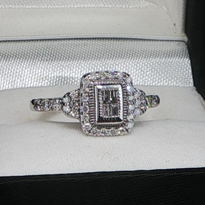 Lot 1071 - A 14ct white gold Art Deco-inspired baguette...