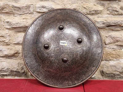 Lot 1123 - An Indian iron shield etched with script...