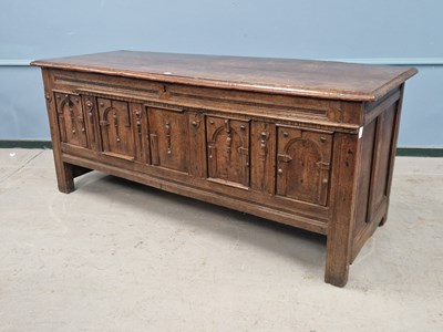 Lot 1315 - An 18th century oak coffer, the front with a...
