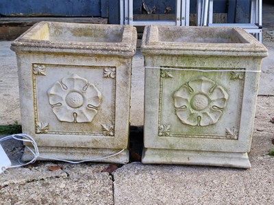 Lot 943 - Two square stone planters with a crest design...