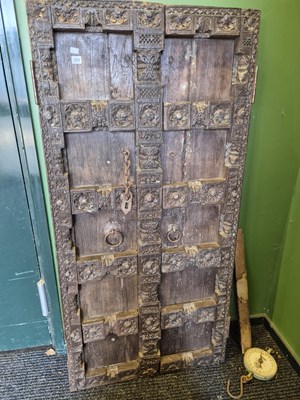 Lot 380 - A heavily carved eastern hardwood door and a...
