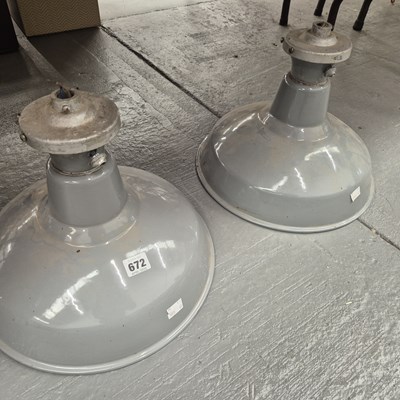 Lot 672 - A pair of grey enamel ceiling light shades. D...