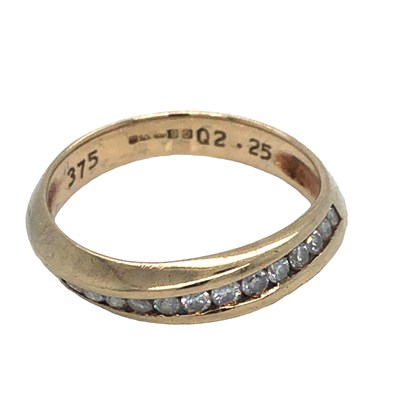 Lot 1249 - A 9ct hallmarked gold and diamond channel set...