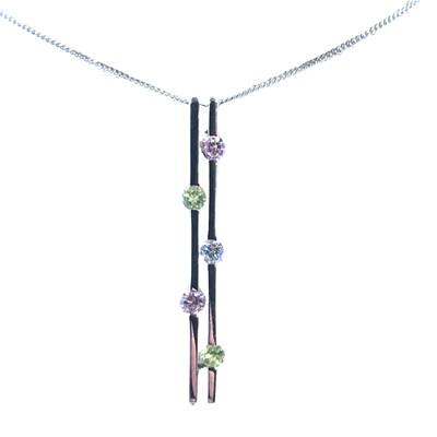 Lot 1251 - A 9ct hallmarked white gold gem-set pendant...