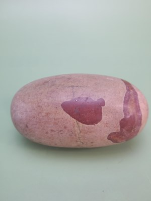 Lot 1755 - An antique river-polished lingam stone with a...
