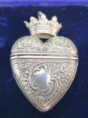 Lot 1399 - A crowned heart shaped silver pendant box,...