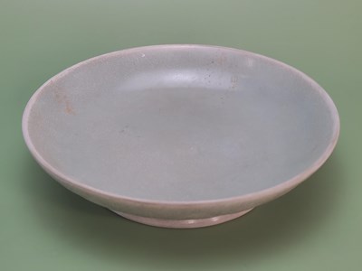 Lot 1416 - A Chinese yue type celadon dish, the underside...