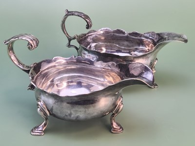 Lot 1419 - A George III silver tripod sauce boat, London...