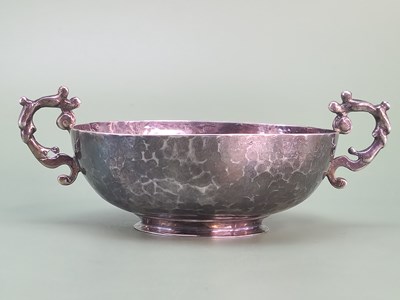 Lot 1420 - A two handled hammered silver shallow bowl,...