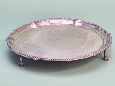 Lot 1424 - A silver tripod waiter, the beaded rim above...