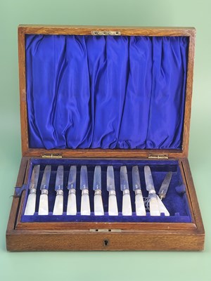 Lot 1433 - An oak cased set of silver bladed mother of...