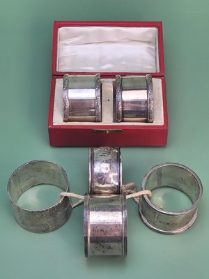 Lot 1437 - A cased pair of silver napkin rings, London...