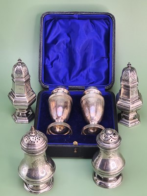 Lot 1438 - A cased pair of silver baluster peppers,...