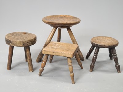 Lot 1448 - Four oak milking stools, two with three legs,...