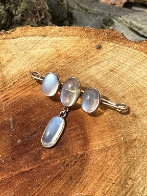 Lot 1022 - An antique bar brooch set with four oval...