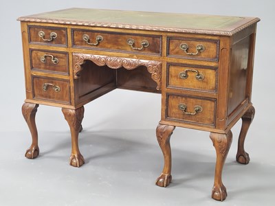 Lot 1501 - A 20th century mahogany kneehole desk, the...