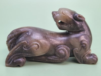 Lot 1522 - A Chinese brown mottled green jade carving of...