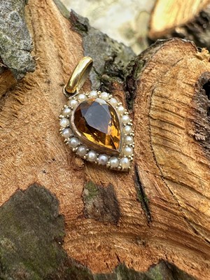 Lot 1052 - A Victorian pear-shaped pendant, centred with...