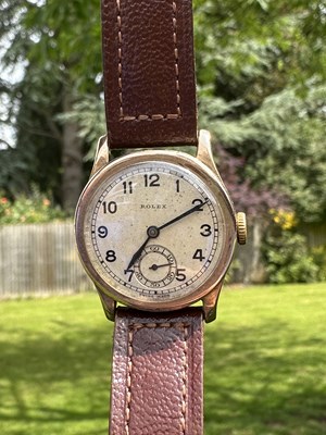Lot 1013 - A Rolex 9ct gold wristwatch, the signed cream...