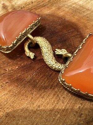 Lot 1005 - Vintage gilt metal and carved orange panel...