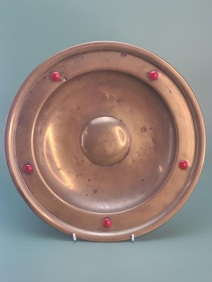 Lot 1784 - A vintage brass charger in the Arts and Crafts...