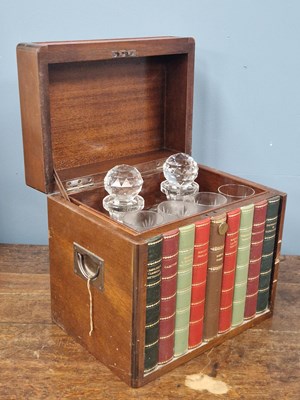 Lot 1839 - A walnut cased tantalus. The rising lid...