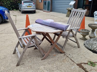 Lot 470 - A hexagonal teak garden table H 74 Ø 102cm,...