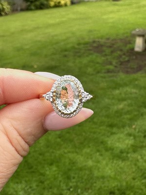 Lot 1045 - A 14ct yellow gold oval aquamarine and round...