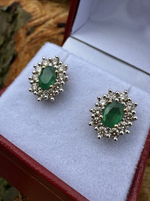 Lot 1054 - A pair of 9ct yellow and white oval emerald...