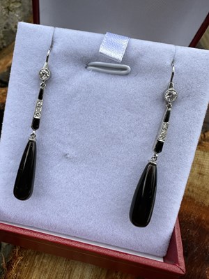 Lot 1019 - A pair of drop earrings set with onyx and...