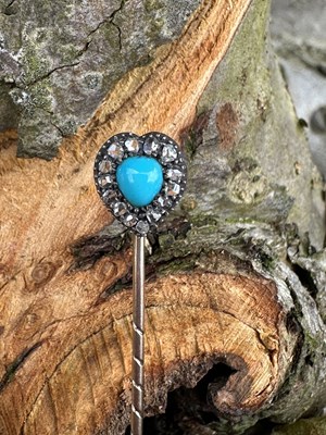 Lot 1194 - An antique heart-shaped stick pin, centred...
